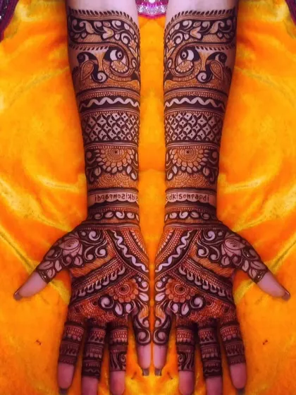 A classic Rajasthani design with symmetrical patterns on both hands. The arms feature bands of peacocks and jaali work, while the palms have a central mandala.