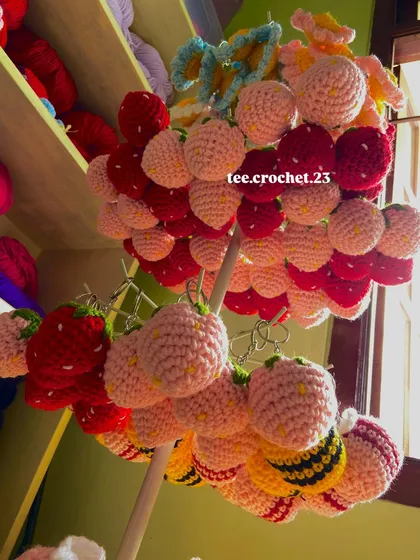 A fun shot of my strawberry and bee keychains hanging on a display stand. I offer these popular designs in different colors for wholesale orders.