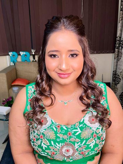 A close-up of the soft glam makeup, featuring defined eyes and a pretty pink lip.