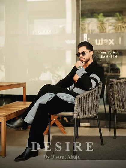 Seated and in charge. This image shows the black and denim fusion co-ord set in a relaxed setting, proving that high fashion can also be effortless.