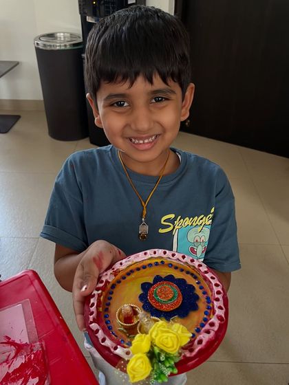 A happy student with his beautifully crafted Rakhi thali, ready for the festival.