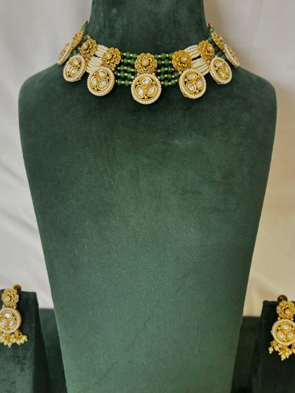 A full view of the unique floral motif choker with matching earrings. This rental set is perfect for adding a touch of elegance to your look.