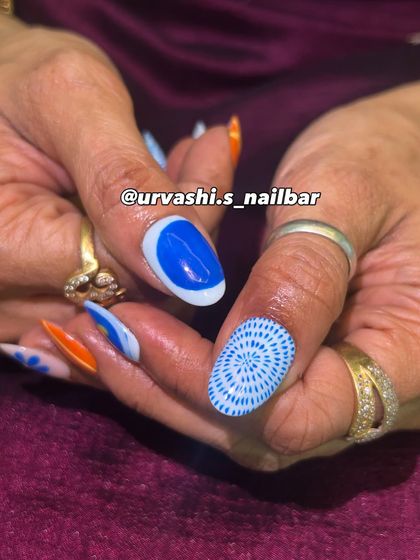 A funky and artistic set with a mix of hand-painted patterns. The combination of bright orange and blue with florals, stripes, and geometric designs creates a bold and unique pop of color.