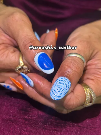 A funky and artistic set with a mix of hand-painted patterns. The combination of bright orange and blue with florals, stripes, and geometric designs creates a bold and unique pop of color.