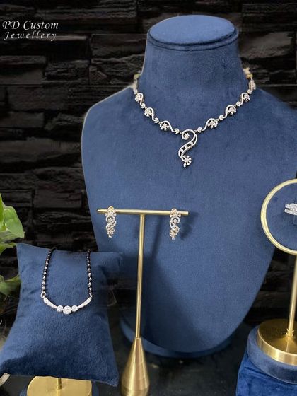 A complete and dazzling bridal or festive set. It includes a diamond necklace, matching earrings, a modern mangalsutra, and a statement diamond ring, all designed to complement each other perfectly.