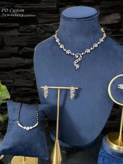 A beautiful display of some of my favorite pieces, including a delicate diamond necklace, a mangalsutra, matching earrings, and a radiant cut ring. Perfect for building your collection.
