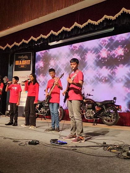 A wide shot of the student band on the Madfit 2023 stage, complete with professional lighting and sound.