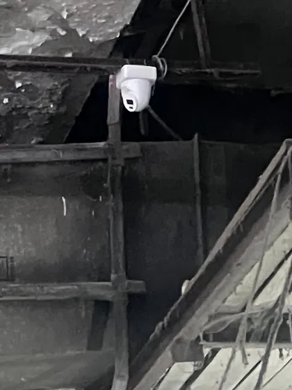 A dome camera mounted on a metal beam in a factory. We can adapt our installation techniques for any type of structure, whether it's concrete, metal, or wood.