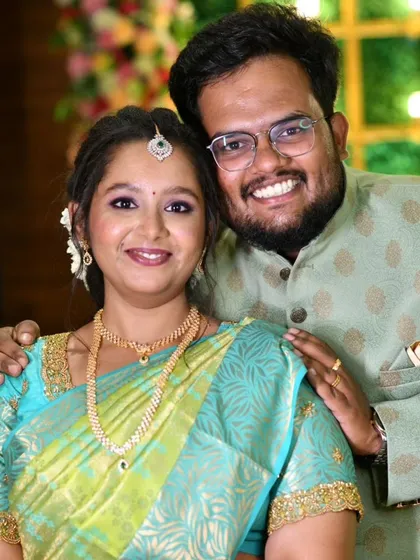 A happy couple during their engagement ceremony. The bride's makeup is fresh and radiant, matching the joyous occasion.