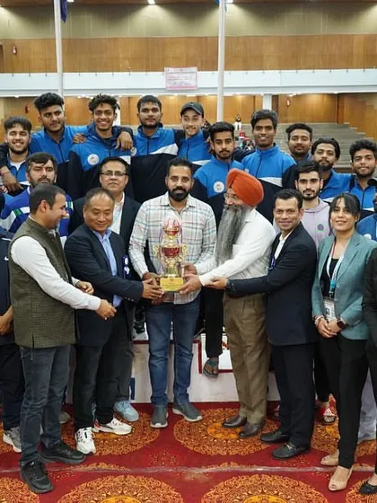 Presenting a trophy to a winning team at the university championships. Recognizing the effort and success of young athletes is a highlight of my role.