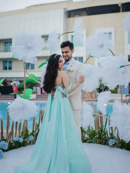 A beautiful photo backdrop for the carnival, with a custom-built structure of giant white paper flowers set against the poolside.