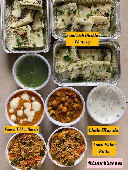 A lunch scene with Sandwich Dhokla, Paneer Tikka Masala, Chole Masala, and Tawa Pulao.