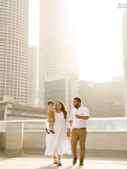 A family walk against the Mumbai skyline. This beautiful outdoor shot captures the joy of a family of three about to become four.