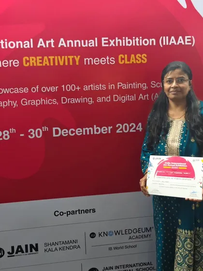 Holding my participation certificate at the India International Art Annual Exhibition. It's an honor to be part of such a prestigious event.