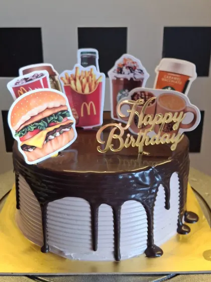 I can create cakes based on any fun theme, even your favorite food spots. This chocolate drip cake was customized with McDonald's and Starbucks toppers for a unique and modern birthday celebration.
