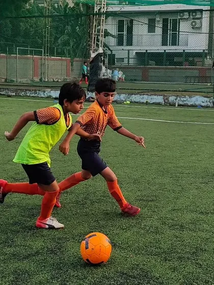 Close competition during a training session. We encourage healthy rivalry to push our players to improve their ball control and defensive skills.