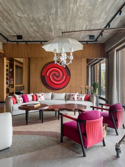A dynamic view of the K Residence lounge, where a vibrant spiral artwork by Arshi Ahmadzai becomes the focal point. The whimsical umbrella chandelier adds another layer of playful design, creating a space that is full of personality and creative energy.