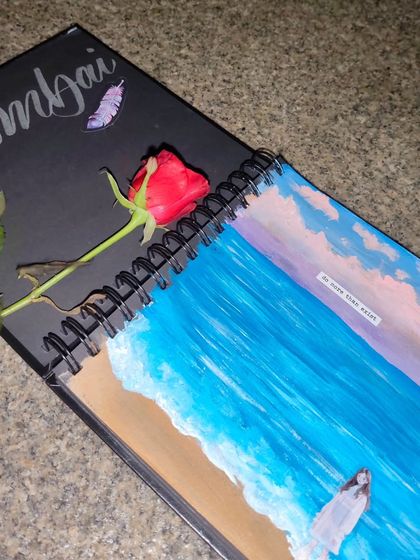 Another shot from my "Mumbai Diaries" series, with my sketchbook and a rose, capturing a moment of creativity and romance.