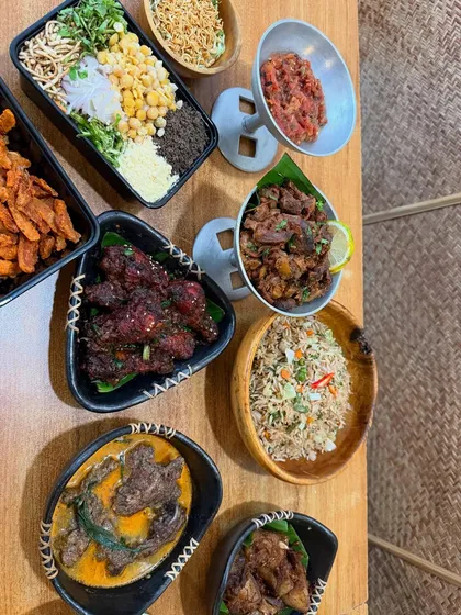 An overhead view of a festive spread, showing the variety of dishes we offer for catering and events. You can see our spicy chicken wings, pork dishes, salads, and fried rice.