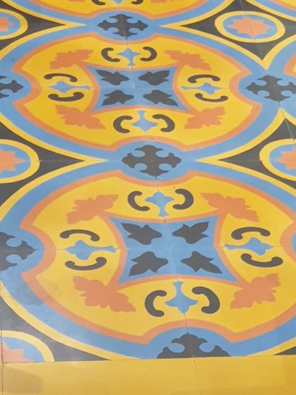 Floors and patterns are one of our passions. This vibrant, colorful cement tile floor adds a playful and artistic touch to the space. The intricate design and bold colors create a joyful and energetic atmosphere.