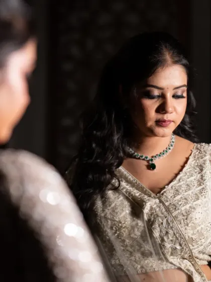 Another angle of the bride-to-be at her mirror, this shot captures a pensive and beautiful moment.