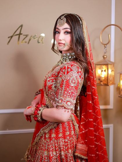 A side profile portrait that highlights the embroidery on the sleeve and the bride's elegant posture.