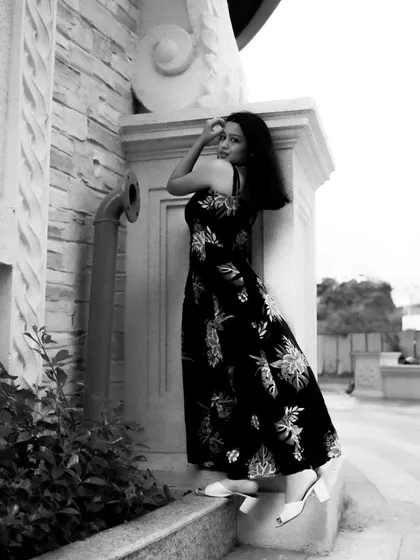 A black and white series exploring different poses against architectural elements. These shots focus on form, light, and the interaction between the subject and her environment.