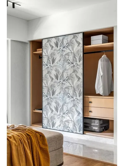 Wallpaper is not just for walls. Here, we used a sophisticated botanical print to turn simple sliding cupboard doors into a statement of chic elegance, proving that every surface is an opportunity for creative expression.