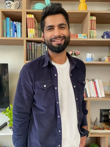A great smile from Harsh Gujral on set. The goal was to create a look that was stylish yet approachable, reflecting his personality as a performer.