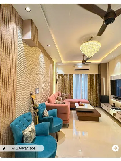 A vibrant living room featuring a stunning 3D textured wall panel as the centerpiece. The combination of a pink L-shaped sofa and turquoise armchairs creates a playful yet elegant contemporary look.