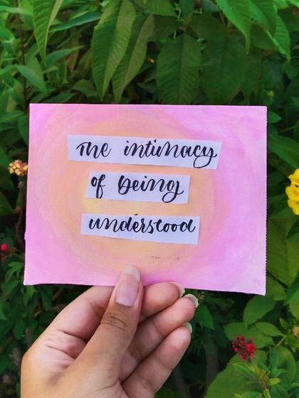 A simple and heartfelt piece with the words "the intimacy of being understood" painted over a soft pink and yellow background.