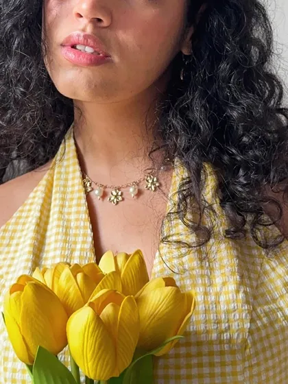 A close-up on the delicate flower necklace I wore with my yellow gingham top.