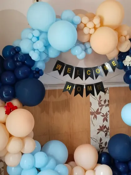 My service is not just for birthdays. I also create beautiful "Welcome Home" decorations for newborns. This balloon arch uses a classy color combination of navy blue, light blue, and peach to welcome the baby.