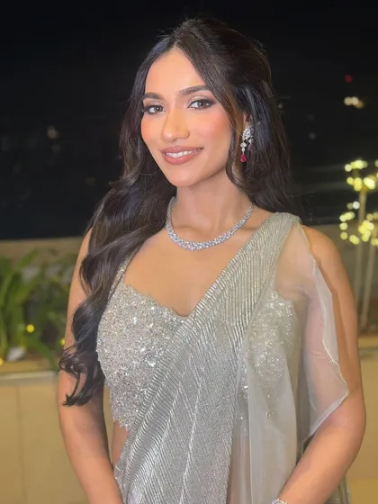 The client looking radiant with her glamorous waves and sparkling jewelry.