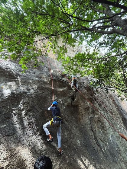 Two climbers make their way up a route, showcasing the different lines available for practice.