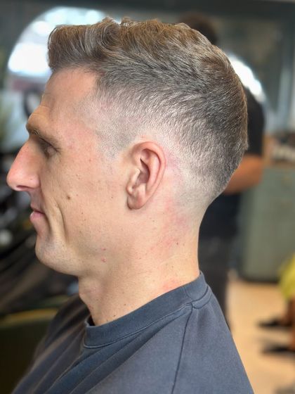 The same modern high fade from a different angle, showing how clean the blend is.