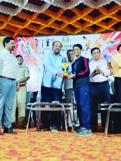 Devaj Parekh receiving his individual championship trophy for the Boys U/12 category at the Poinsur Gymkhana meet.
