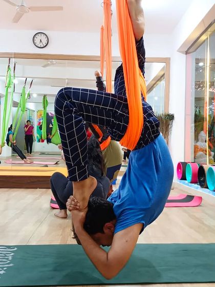 A deep, supported inversion in the aerial hammock, perfect for advanced practitioners looking to explore new variations.