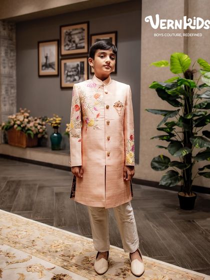 Our floral embroidered sherwani in a soft peach hue is the definition of grace. The delicate threadwork on the sleeves and chest adds a touch of nature-inspired beauty, crafted from breathable fabric for complete comfort.