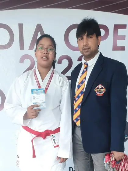 A student in her red belt gi after competing at the India Open. Every match is a lesson.
