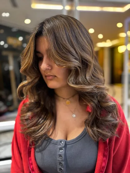 The soft, face-framing layers are enhanced by the no-bleach balayage colour.