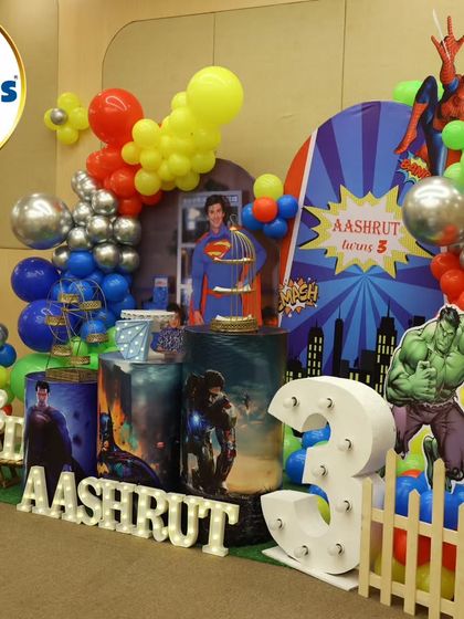 An action-packed superhero theme for a 3rd birthday. We assembled the mightiest heroes with life-sized cutouts of Superman, Batman, Hulk, and Spider-Man, complete with a city-scape backdrop and bold, primary-colored balloon decorations.