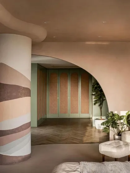 A view from the master bedroom into the walk-in closet, showcasing the use of color and texture, as featured by FOAID.