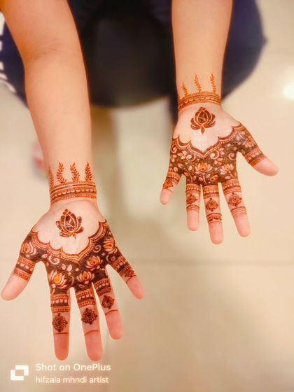 A lovely shot of the matching lotus designs for a mother and daughter celebrating Diwali.