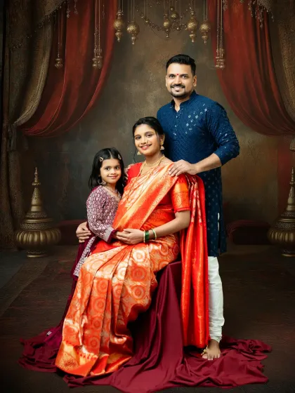 I love creating timeless family portraits that honor our culture. Here, the entire family comes together in traditional attire for a regal and warm maternity photo, celebrating the new life that will soon join them.