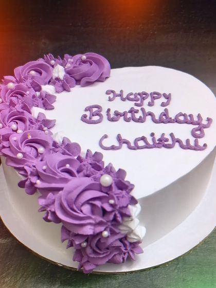 A simple and healthy heart-shaped cake. This is a whole wheat vanilla cake with beautiful purple floral piping on one side.