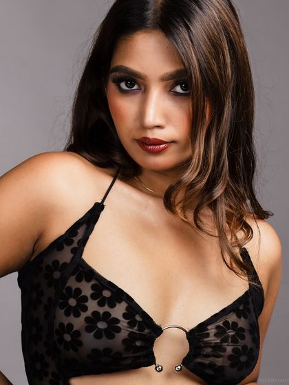 A direct and powerful portrait of the model in the sheer black dress.