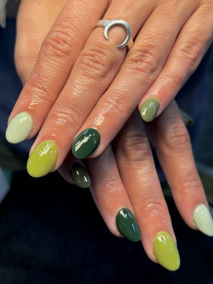 A close-up of the green spectrum manicure, highlighting the different tones from light to dark.