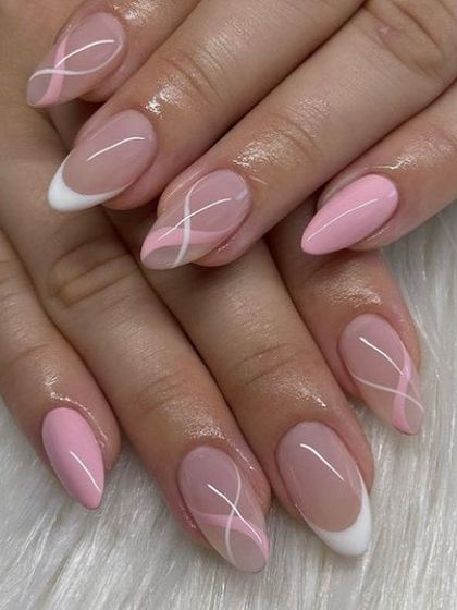 A soft and pretty design combining solid pink nails, a white French tip, and abstract white line art on a sheer pink base.