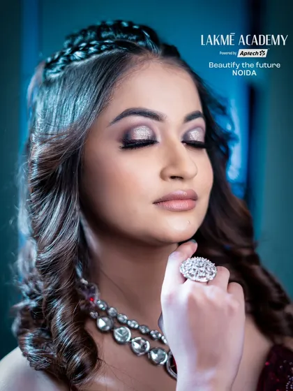 A detailed close-up of a soft glam eye. The silver shimmer on the lid and the subtle winged liner create an elegant and sophisticated look that our students master.